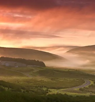 An atmospheric sunrise photograph of our farm in Elan Valley - taken by photographer Mike H when filming the farm for S4C's DRYCH: HEL Y MYNYDD shown on January 2020. Permission granted for Tanya & Erinna and WildSherpherd website use. Copyright: All rights reserved via Erinna & Tanya WildShepherd.